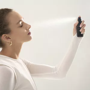 Person spraying Hydrating Fix Mist on their face